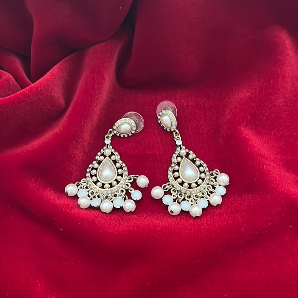 Gold tone and faux pearl earrings.